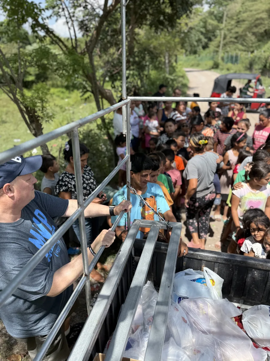 Volunteers distributing food and supplies to community members