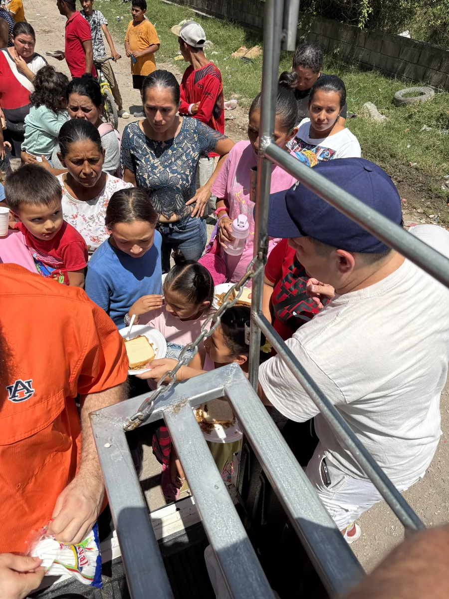 Volunteers serving food to children and families