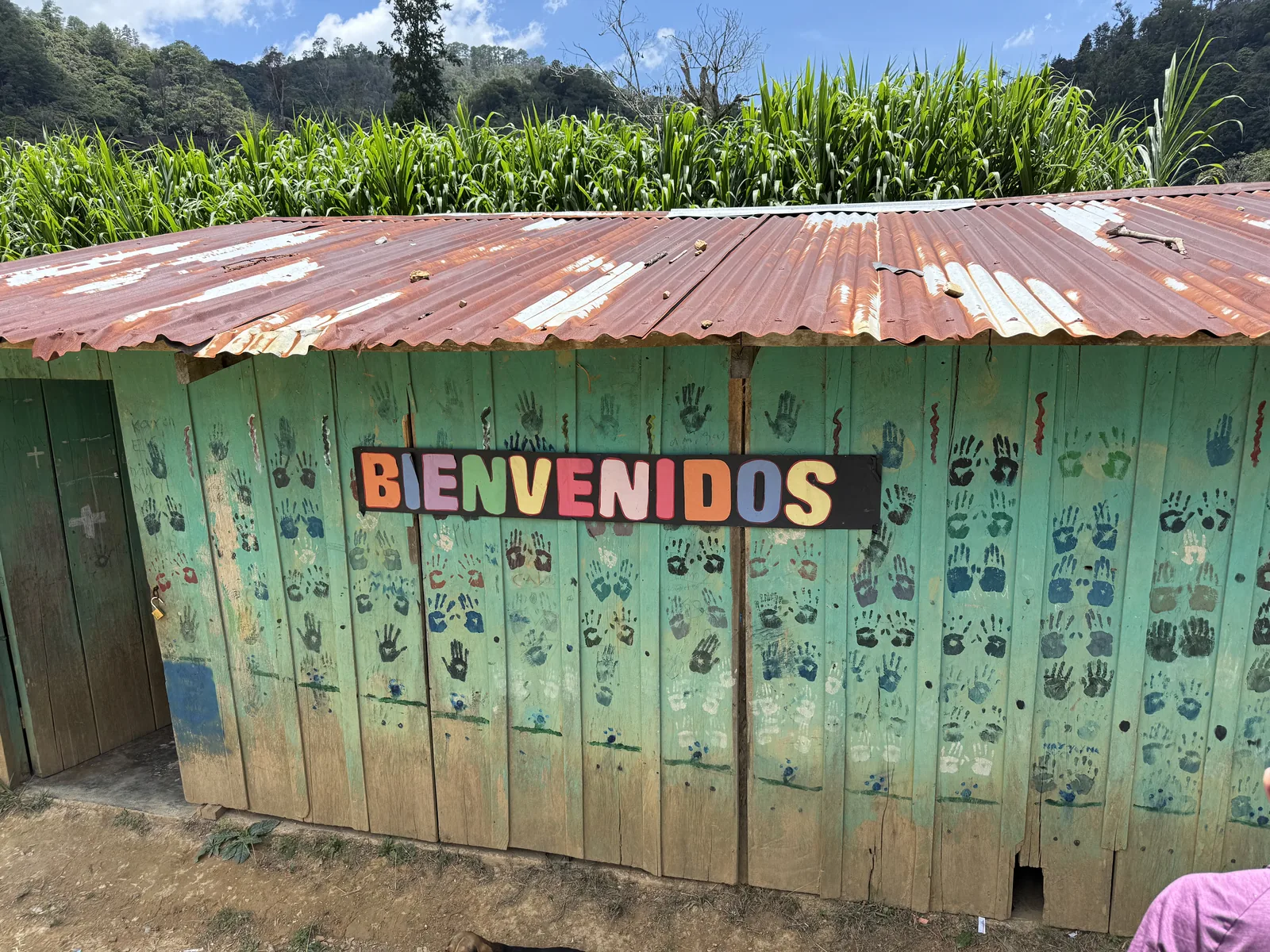 Rural community building with a colorful Bienvenidos welcome sign